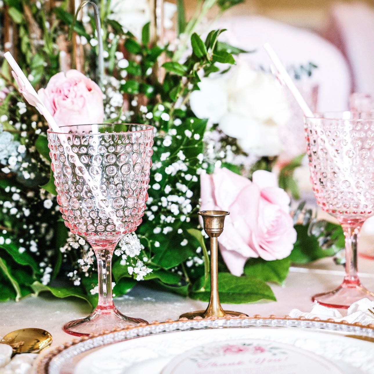 Pink hobnail glassware and place setting with roses and baby's breath